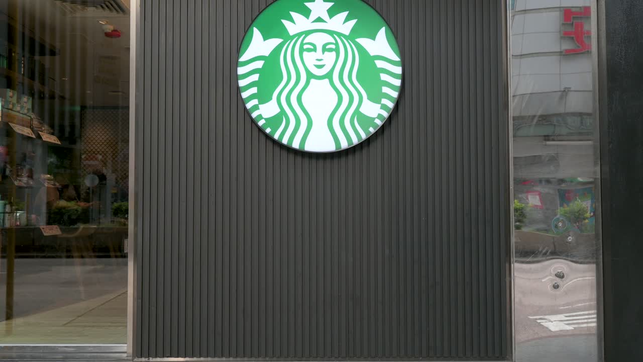 The logo of Starbucks, the American multinational coffee chain, is prominently displayed outside its store in Hong Kong, China.