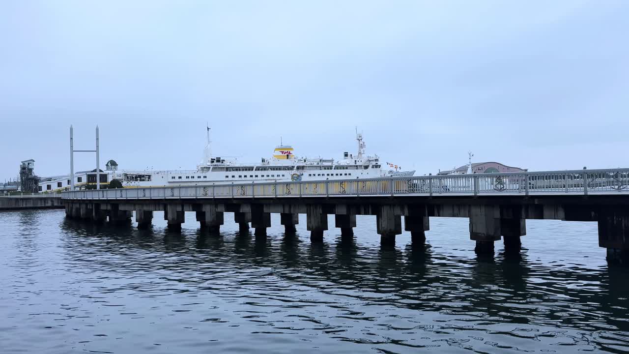 Ferry docked at Aomori Bay, calm water view with cloudy sky and peaceful mood