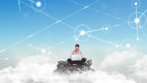 Businesswoman-using-laptop-in-the-clouds