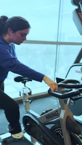 young woman doing spinning exercise at the gym