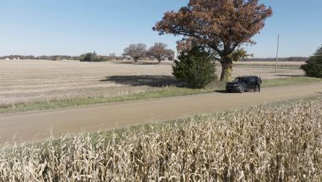 Country-Road-Man-is-having-car-issues-and-an-opening-the-trunk