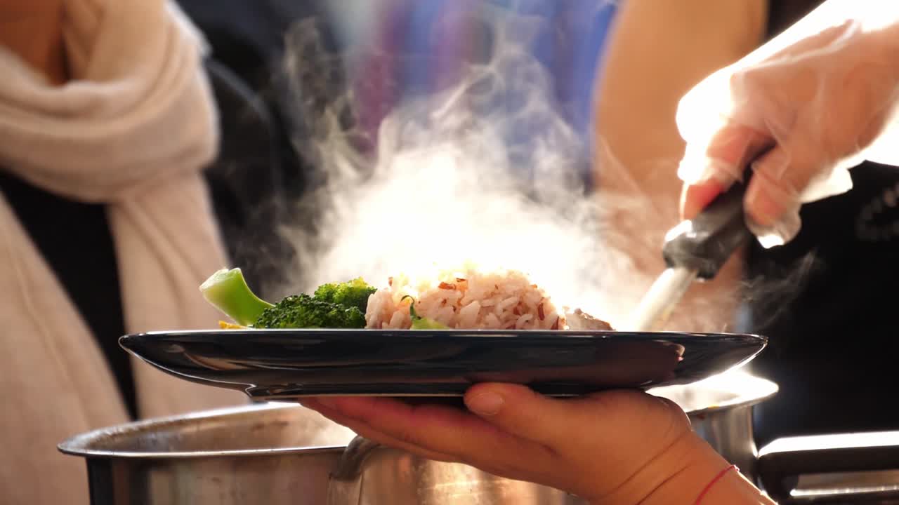 Slow motion speed inconsistently light scene of pork leg stew with sweet gravy sauce putting on rice in dish