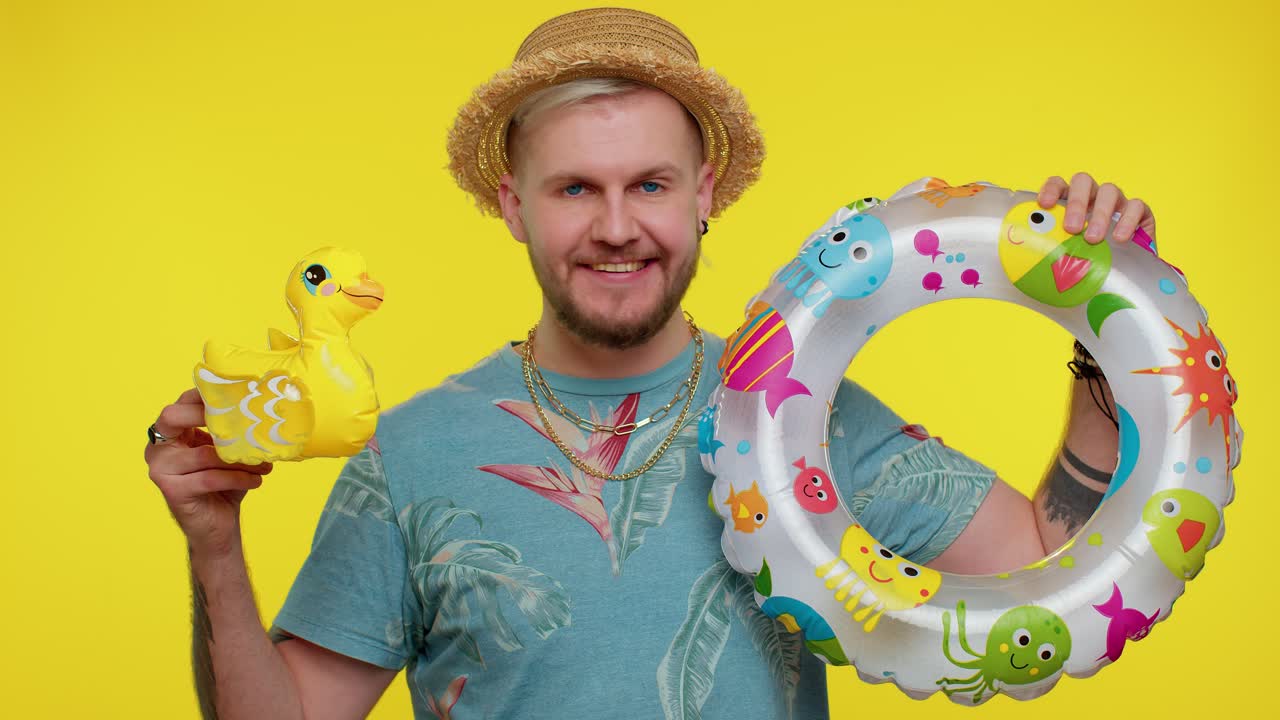Traveler tourist adult man dancing fooling with swimming ring and duck toy travel on weekends