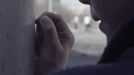 child drawing on a wall