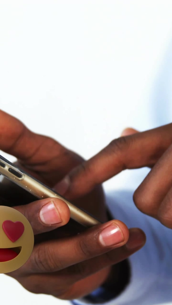 Animation of emoji icons over african american businessman using smartphone