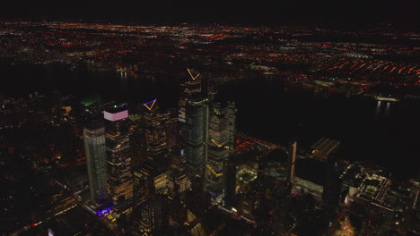 Aerial-panoramic-view-of-large-city-at-night.-Residential-complex-of-high-rise-buildings-on-Hudson-river-waterfront.-Manhattan,-New-York-City,-USA