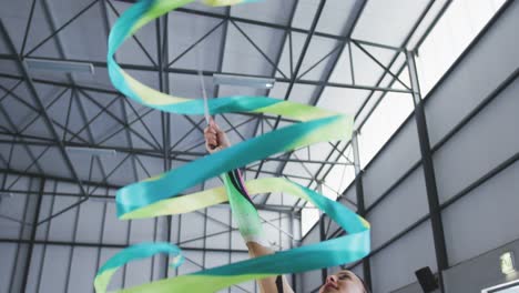 female gymnast performing at sports hall