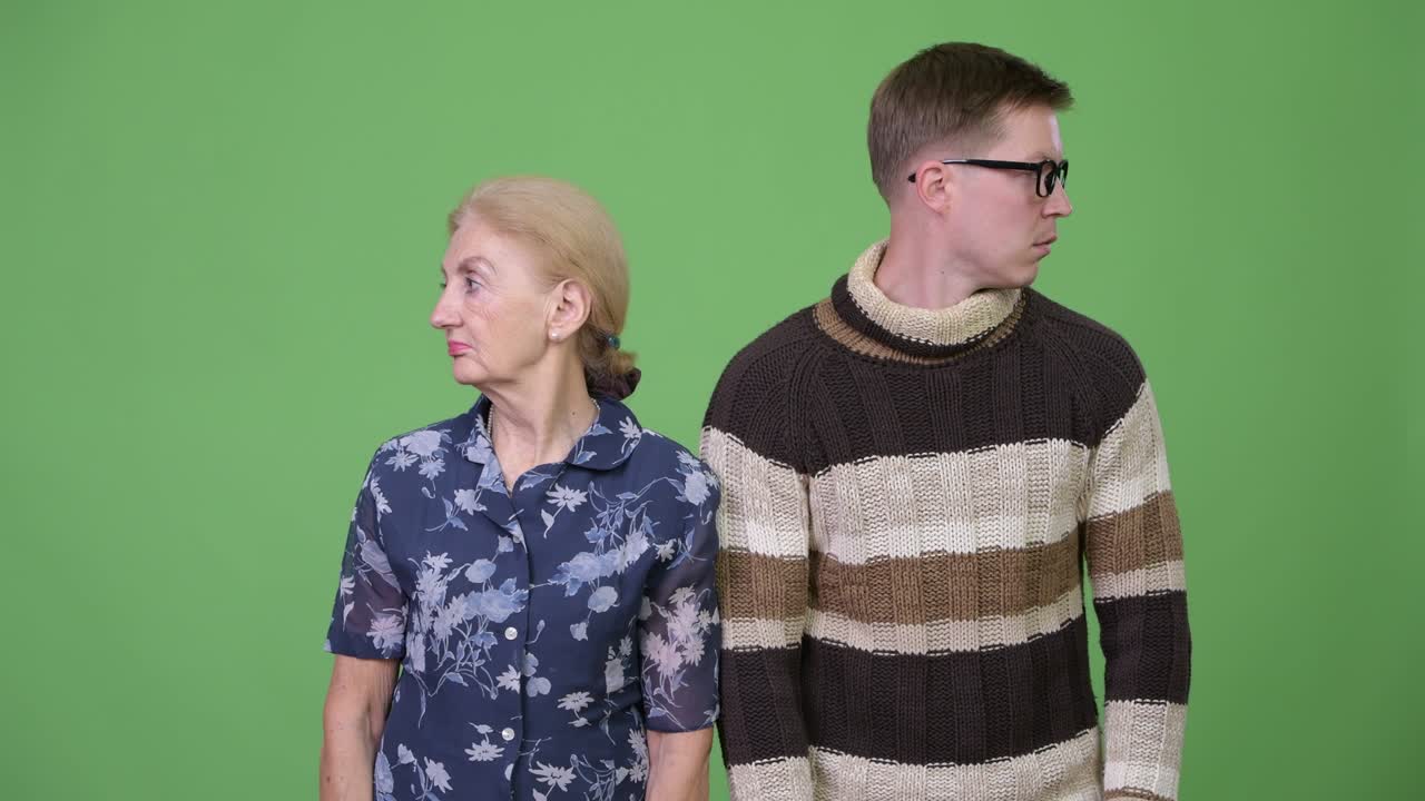 Grandmother and grandson looking away in different directions together