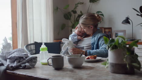 happy young mother playing with baby at home smiling enjoying motherhood playfully caring for cute infant