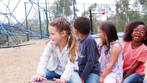 elementary school kids spinning in a playground