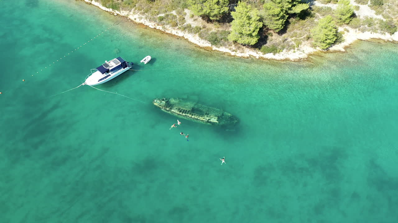 Yacht Float On Blue Water Next To Shipwreck Sank In The Sea In Solta, Croatia. - aerial