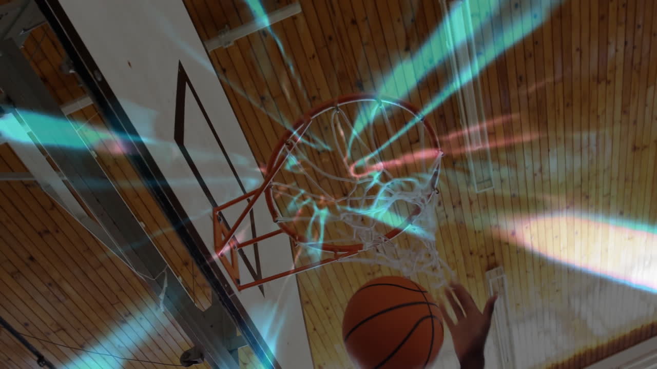 Basketball player shooting ball towards hoop with colorful light trails animation