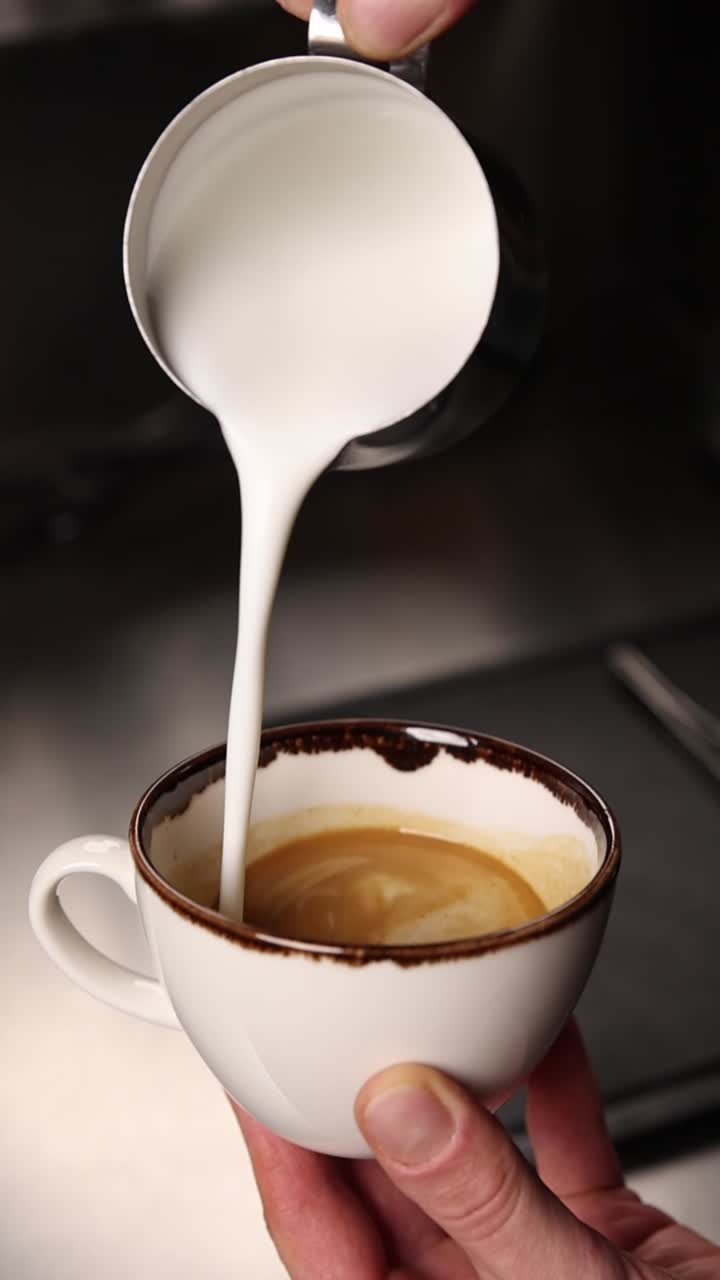 Pouring milk into a latte