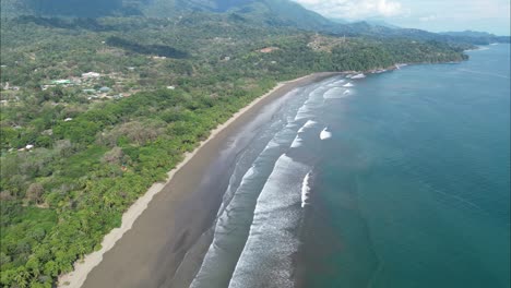 flying into costa rica coast with a drone with mountains in the background