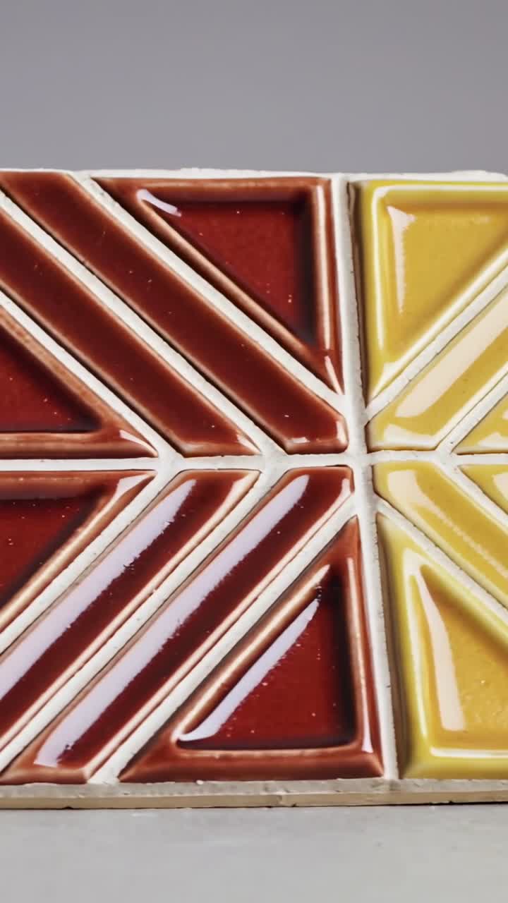 Vertical video: Panning camera revealing ceramic blocks on tabletop, unveiling blue red yellow set