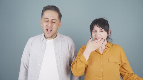 couple yawning at camera. they are sleepless.