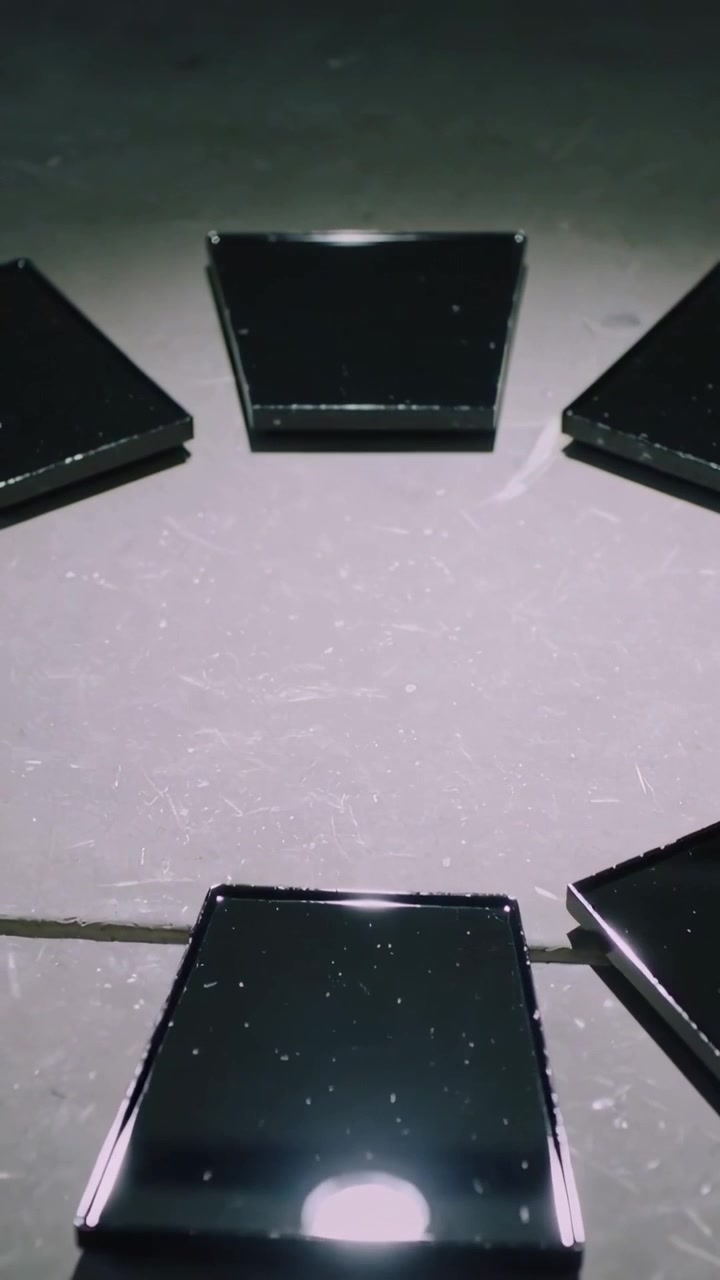Vertical video: Sliding bottom tile from glossy black ring along table seam, exposing inner gap