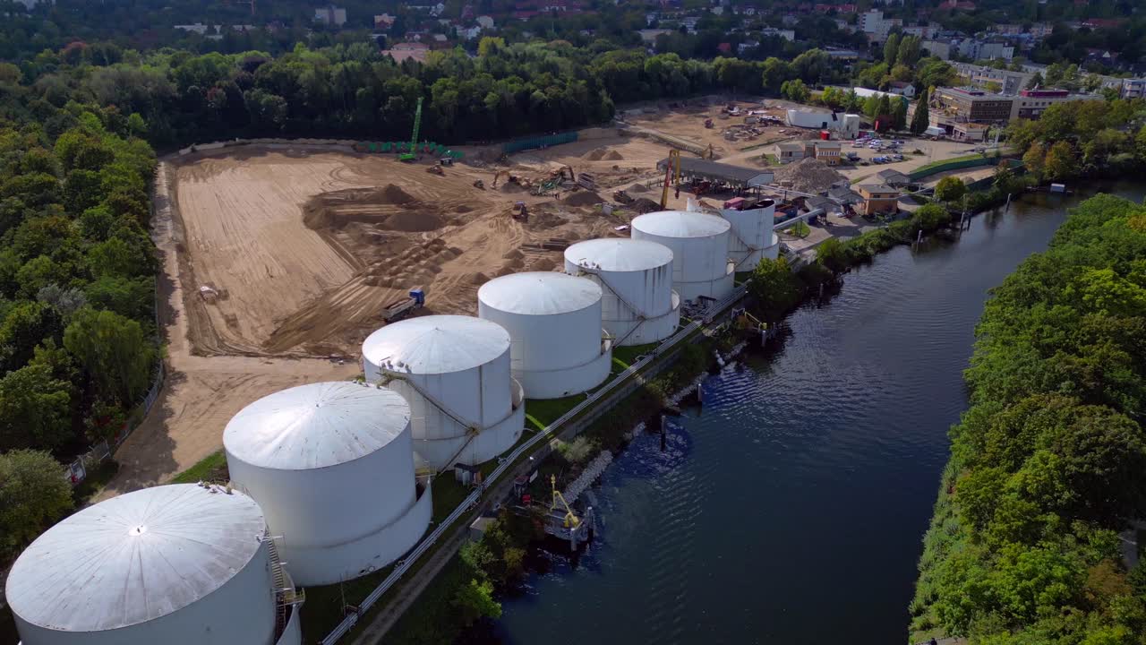 Decommissioning of Storage depot for petroleum products storage silos and containers. Industrial storage tanks holding oil and gas products. Gorgeous aerial view flight descending drone
