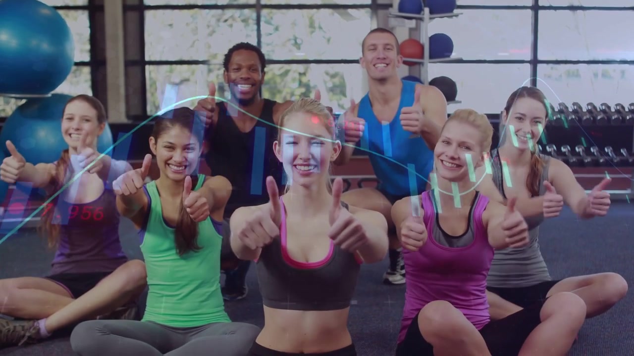 Vertical video: Reacting to camera start, group in studio in gymwear giving thumbs up by blue balls