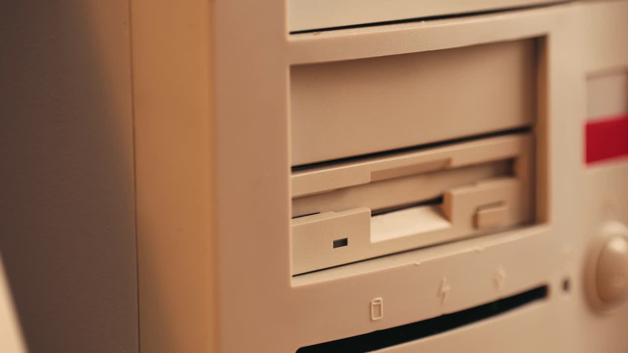 Using diskette for old computer. Music recorder, playing retro computer games. Vintage device for office, obsolete technology. . High quality 4k footage