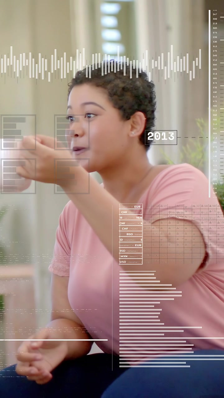 Vertical video: Woman sipping mug in living room reacting to offscreen data cue as charts updating