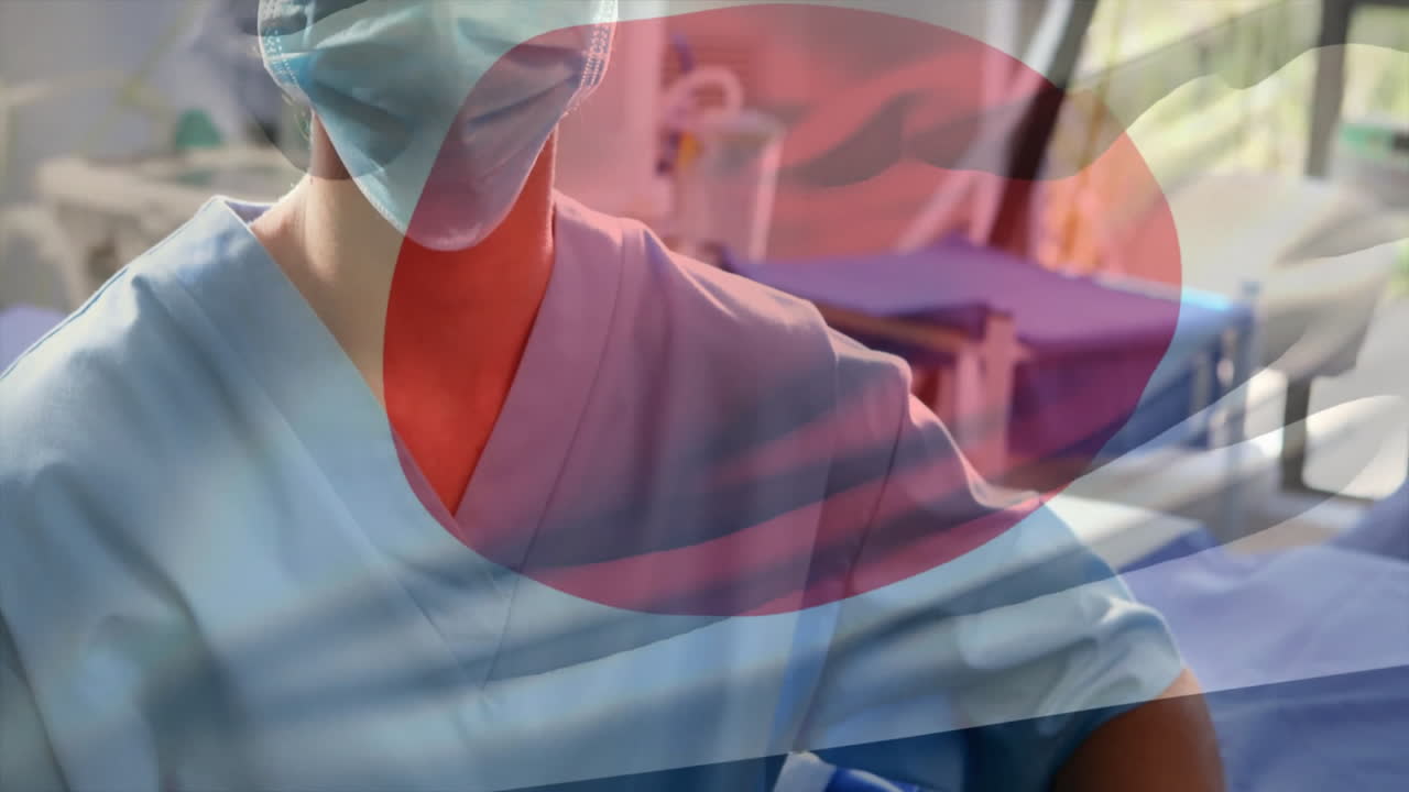 Animation of flag of japan over biracial female surgeon with face mask