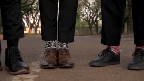 several men's dress shoes and fun socks on the street
