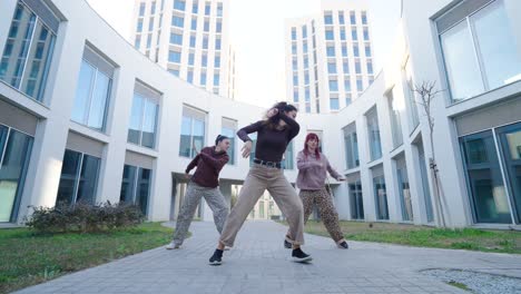 young women dancing modern choreography outdoors