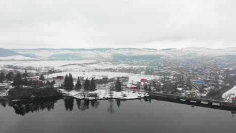 aerial view over a snowy dam in romania