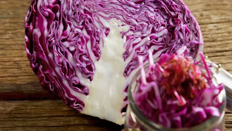 chopped and halved red cabbage on wooden table 4k