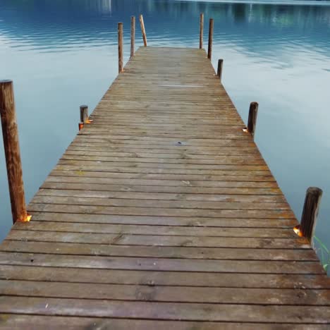 steadicam shot: old wooden pier on a picturesque mountain lake in the alps in austria 2