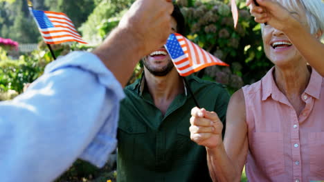 family holding american flags in the park 4k