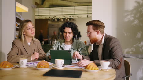 three business people meeting in a cafe