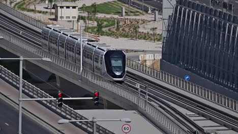 a dubai tram moves along sheikh zayed road at dubai marina in the uae.