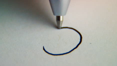 -Macro-slow-motion-shot-of-a-pen-drawing-a-frown-face