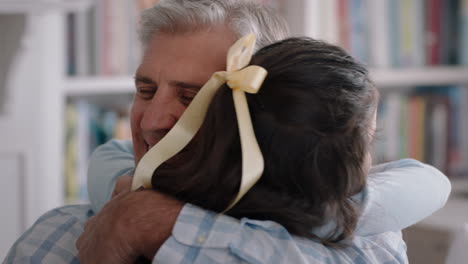 grandfather hugging granddaughter happy little girl embracing grandad enjoying affectionate hug from child sharing love gently holding grandparent at home