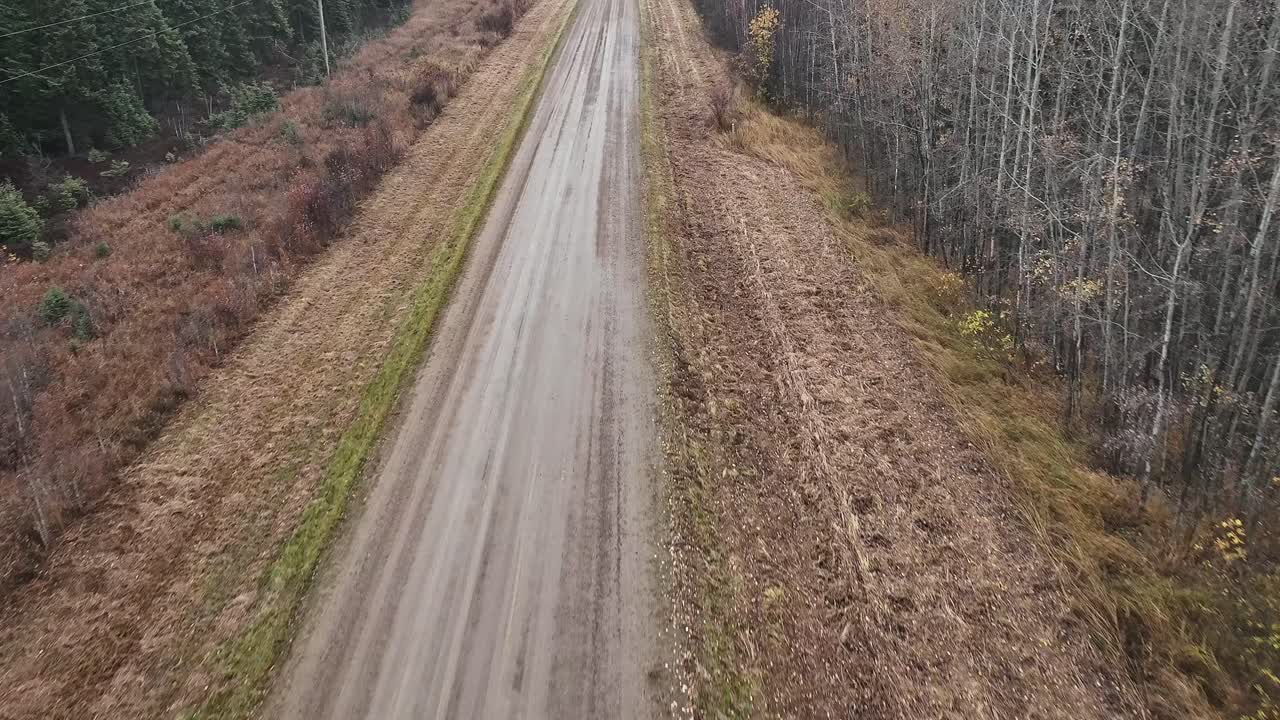 Drone flying over a wet country road in the autumn
