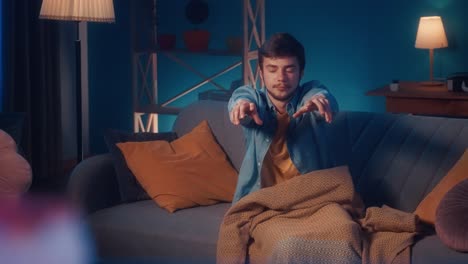 Man Sleeping and Sitting on a Couch at Night