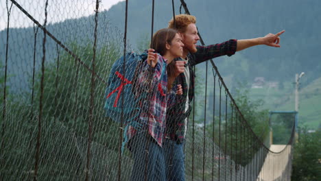 two friends exploring mountains on summer holiday. travelers rest on hitchhike.