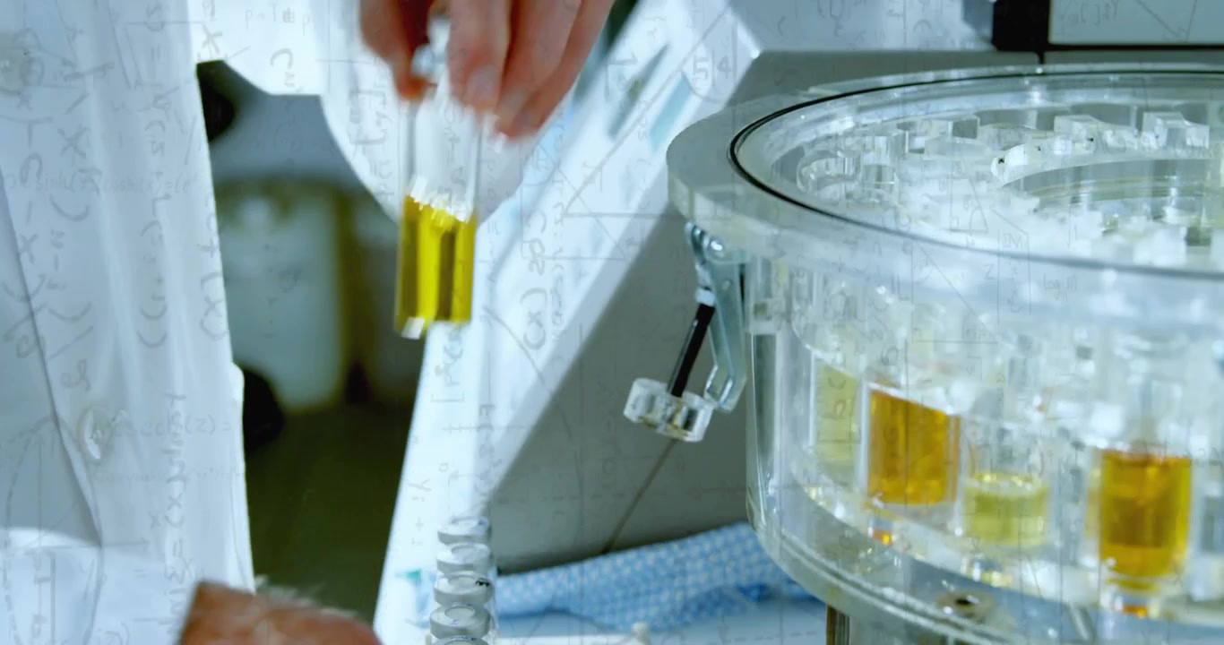 Senior man right-hand reaching and picking vial from carousel, adjusting knob, loading lab samples