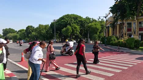 people crossing a street in bangkok, thailand