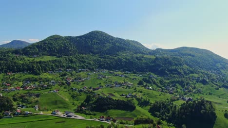 mesmerizing aerial view of huts and cottages on the green mountains of tourist destination city of velenje, slovenia