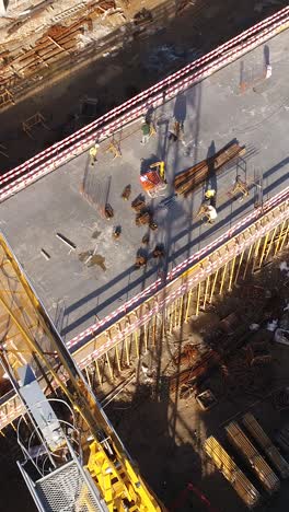 vertical video construction site workers in action