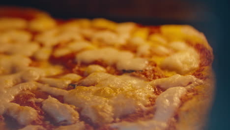 close up of homemade pizza being baked in hot oven