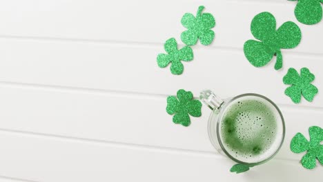 Video-of-st-patrick's-green-shamrock-and-green-beer-with-copy-space-on-white-background