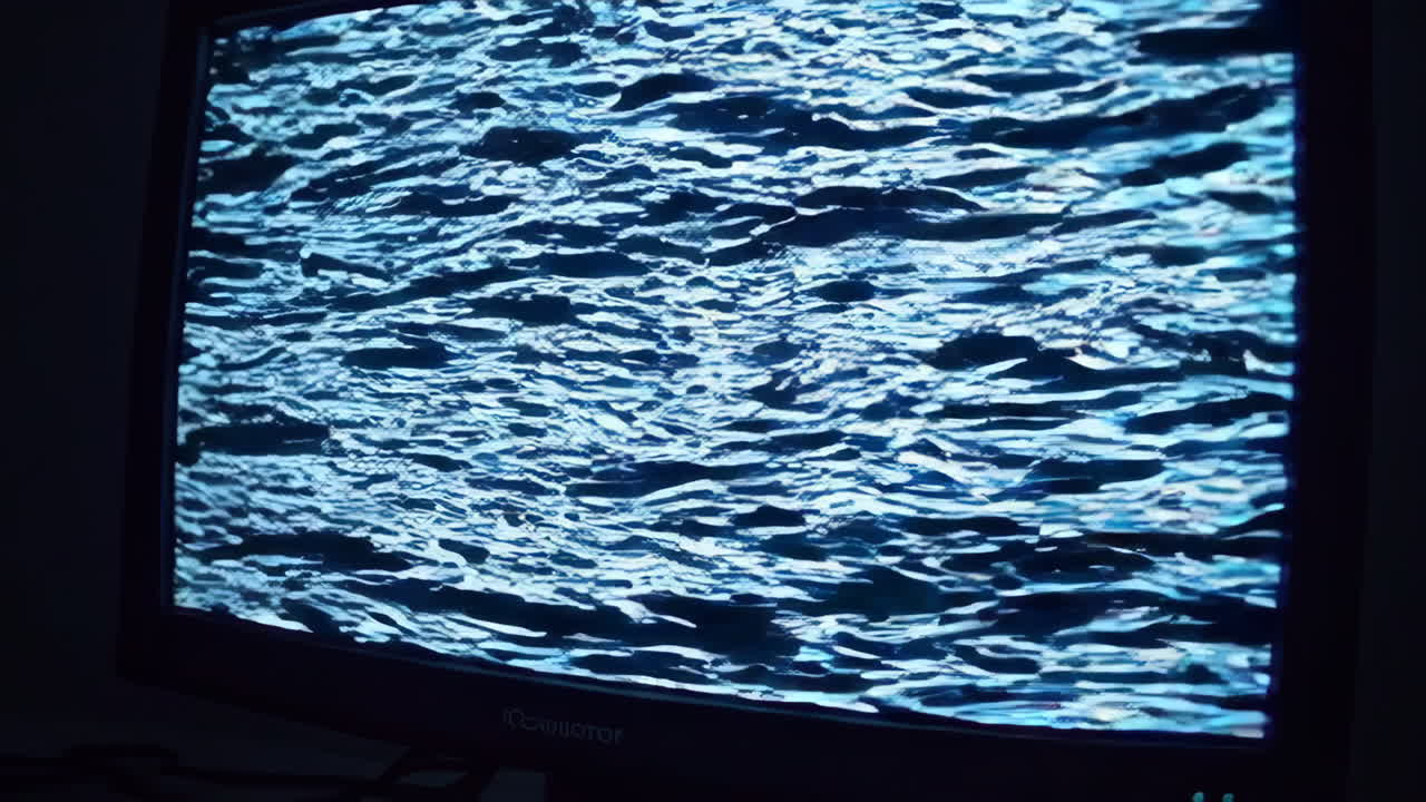 Person Looking at a Broken Computer Monitor in a Dark Room