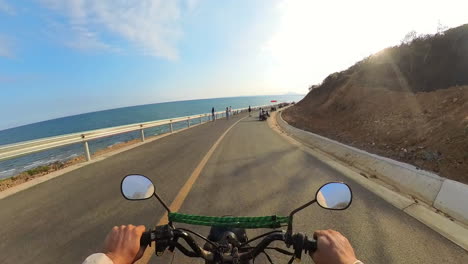 motorbike pov action shot. travel, vacation, and beach tourism in binh thuan, vietnam, southeast asia.