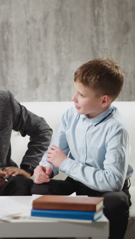 smart little students answer smiling african-american educator in glasses questions during english lesson with native speaker at home slow motion