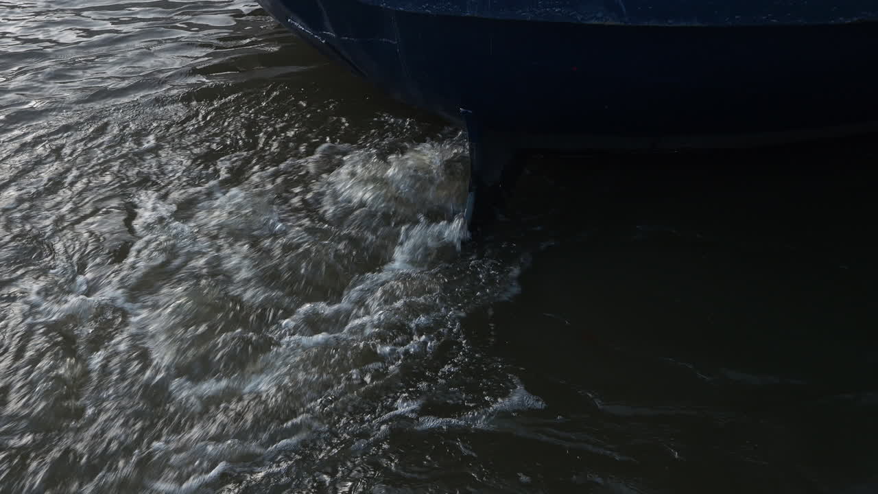 Boat with a motor under water splashing the water surface