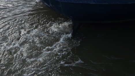 boat with a motor under water splashing the water surface